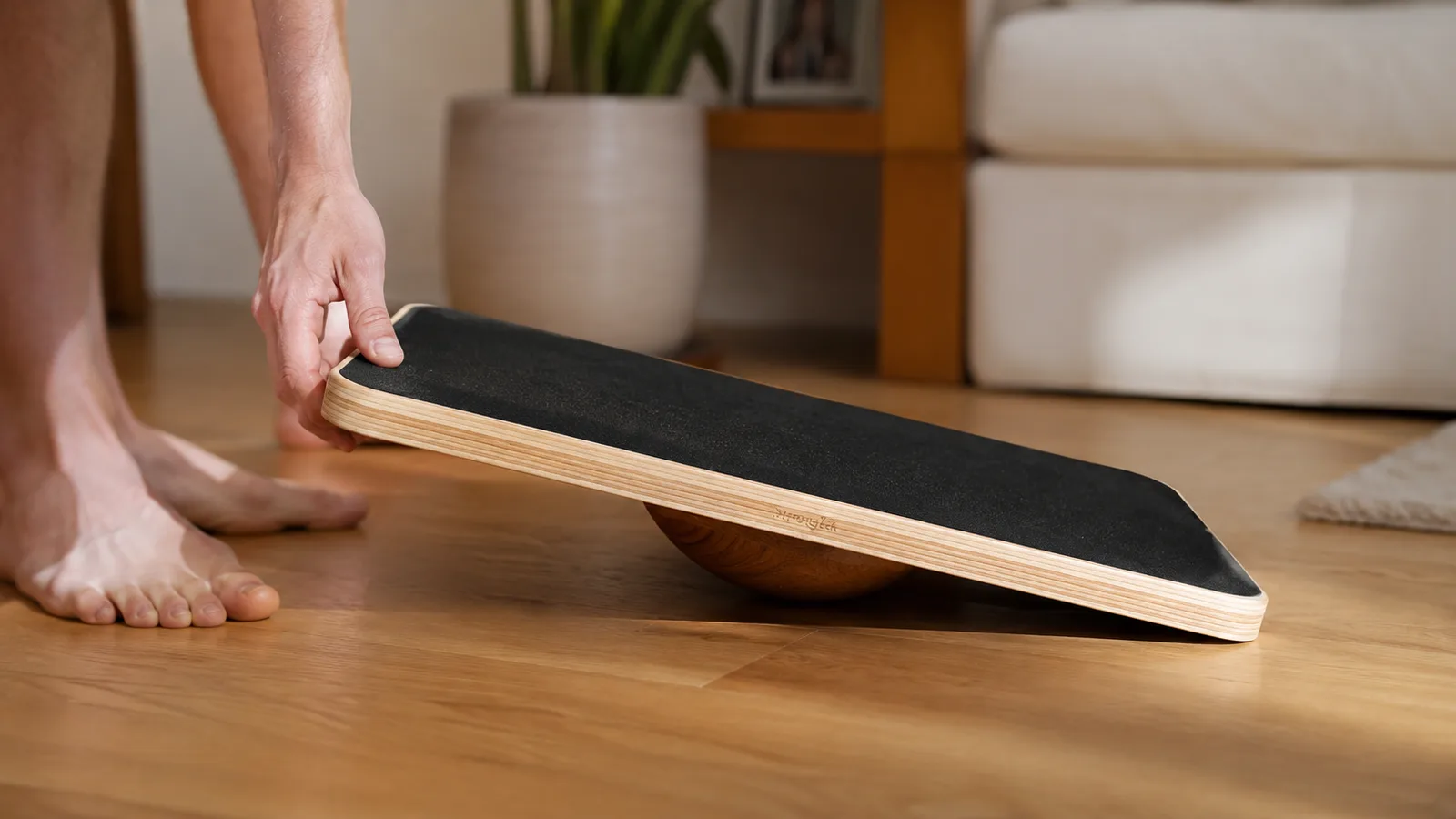Close-up of the two sides of the wooden balance board showing the flat rocker base and the rounded wobble base